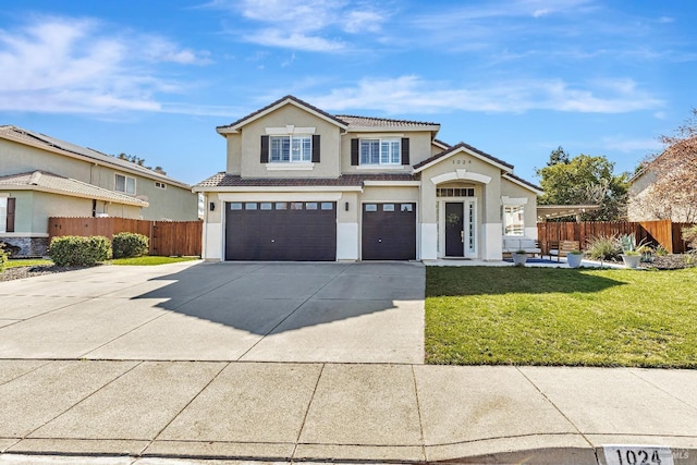 traditional-style home with a front yard, fence, an attached garage, and stucco siding