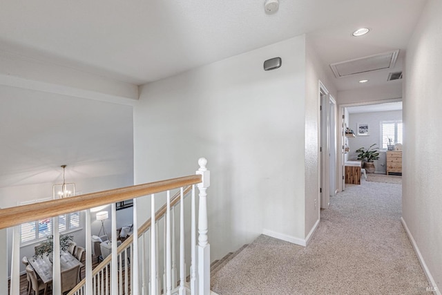 corridor with carpet floors, recessed lighting, visible vents, an upstairs landing, and baseboards