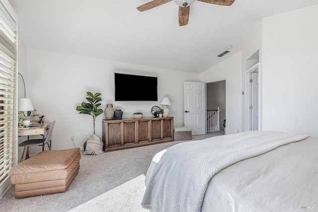 carpeted bedroom with vaulted ceiling, ceiling fan, and visible vents