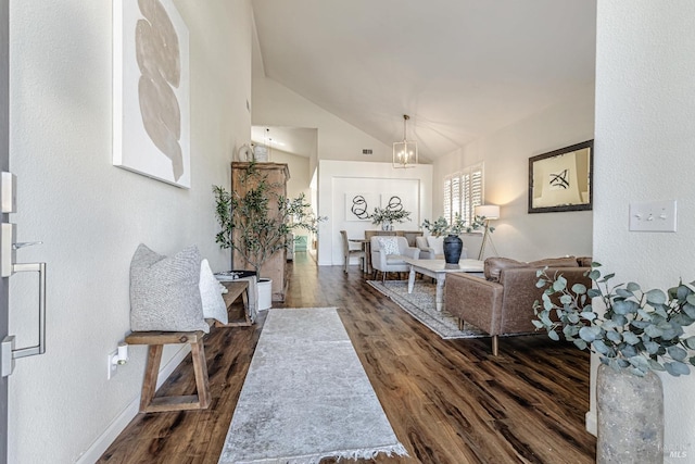 living area with a chandelier, dark wood-style flooring, and baseboards