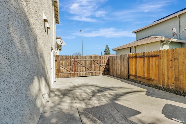 view of patio with a gate and fence