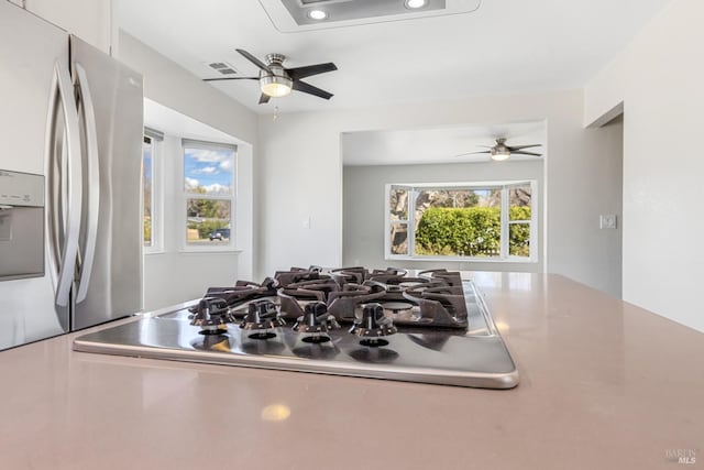 interior details featuring ceiling fan, appliances with stainless steel finishes, and visible vents