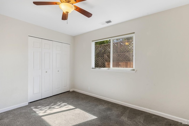 unfurnished bedroom with a closet, visible vents, carpet flooring, ceiling fan, and baseboards