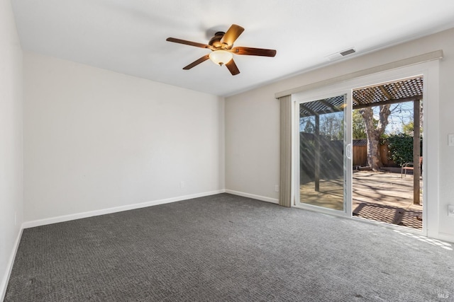 carpeted empty room featuring a ceiling fan, visible vents, and baseboards