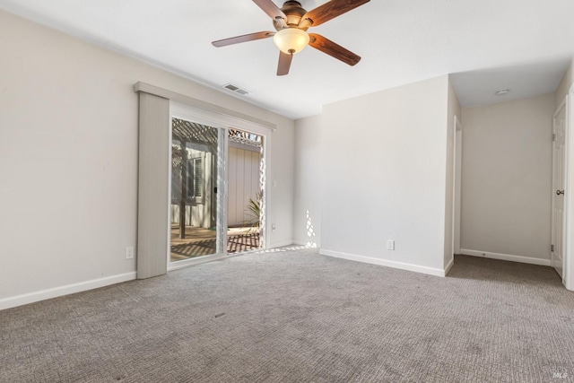 unfurnished room with carpet floors, baseboards, visible vents, and a ceiling fan