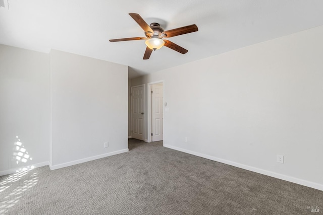 empty room featuring ceiling fan, carpet flooring, and baseboards