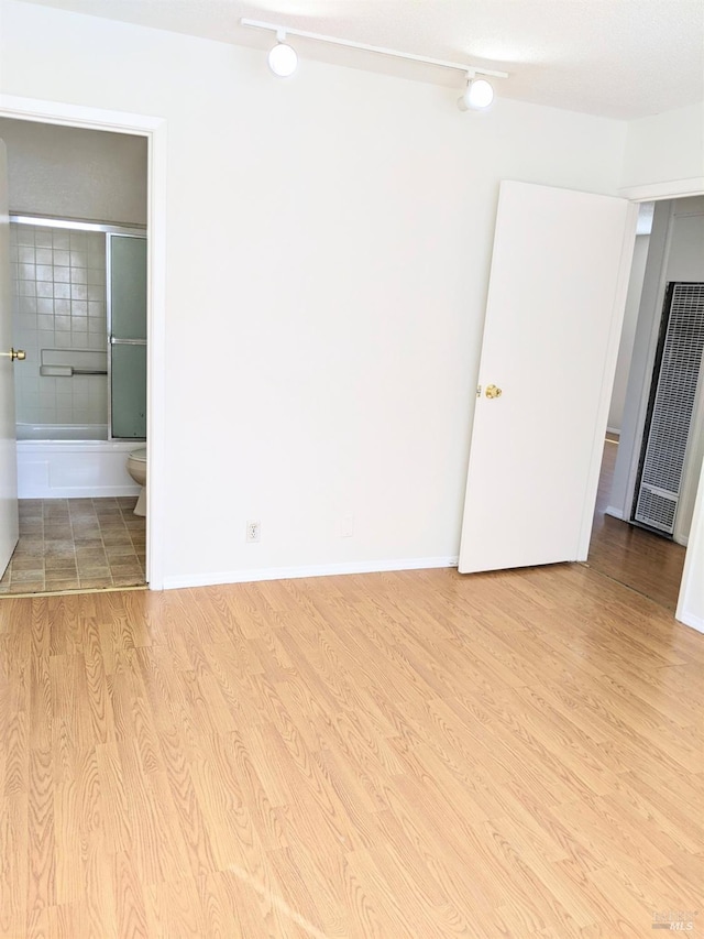 interior space featuring baseboards and wood finished floors