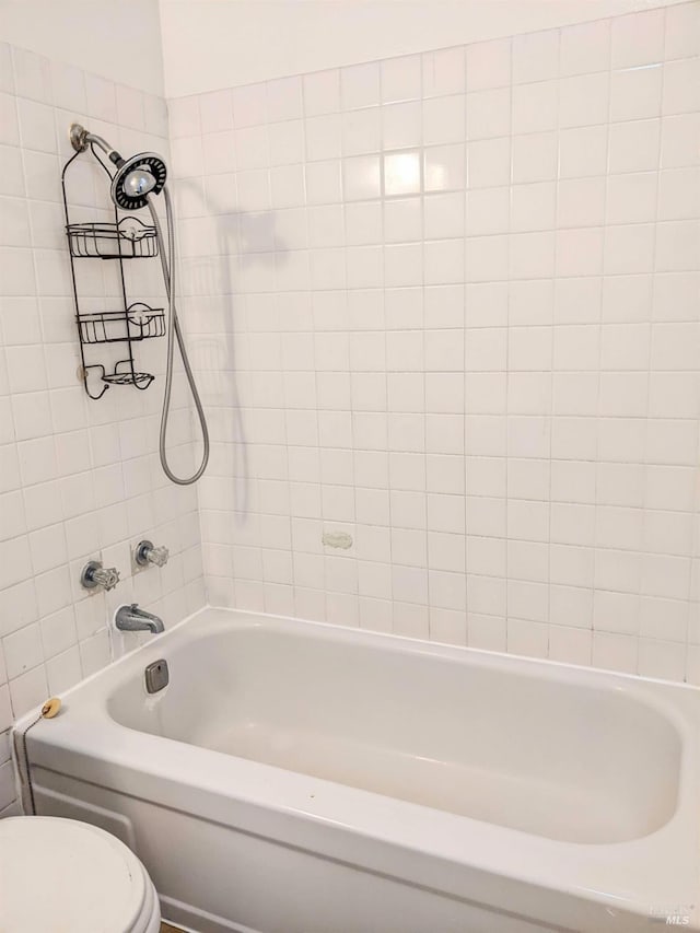 bathroom with toilet and shower / washtub combination