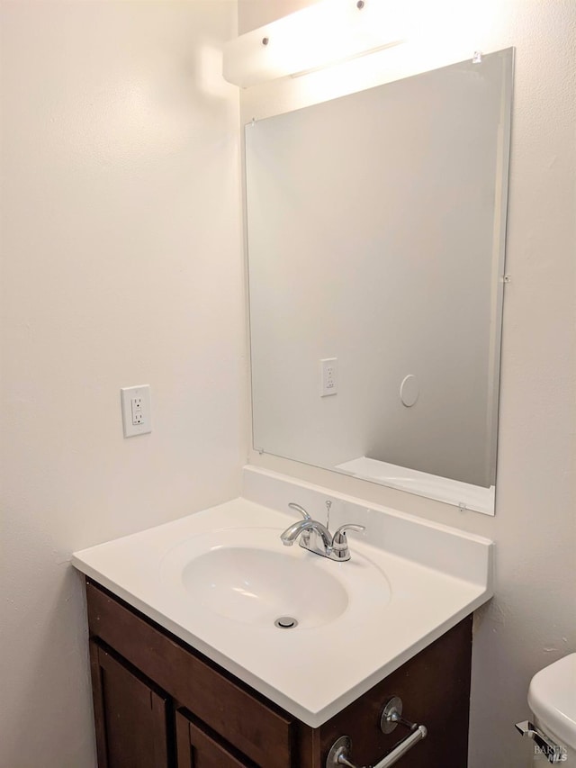 half bath featuring toilet and vanity