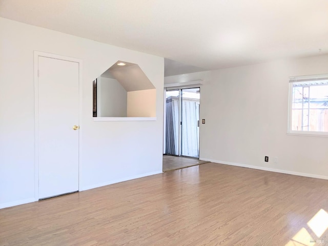 spare room with wood finished floors and baseboards