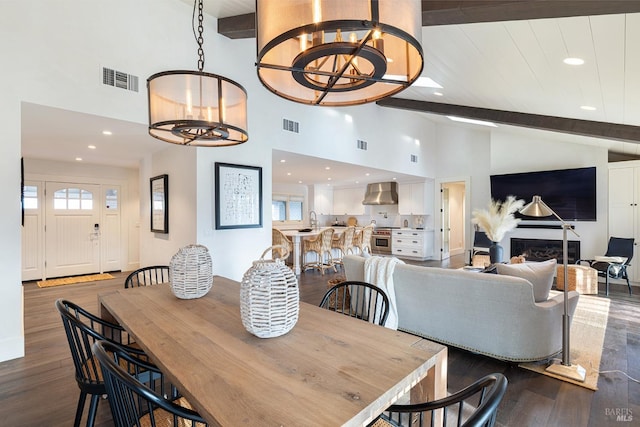 dining room featuring beamed ceiling, dark wood finished floors, visible vents, and a notable chandelier