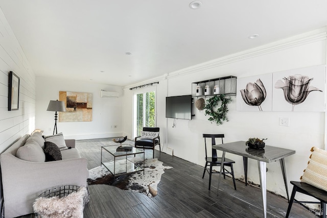 living room with dark wood-type flooring, an AC wall unit, and crown molding