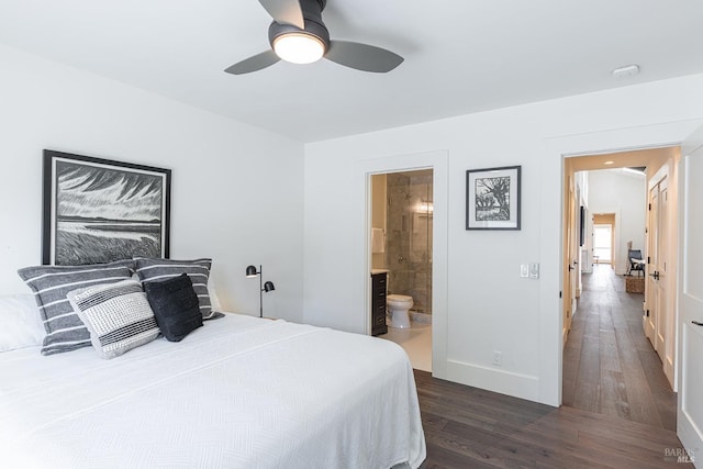 bedroom featuring ceiling fan, dark wood-type flooring, connected bathroom, and baseboards