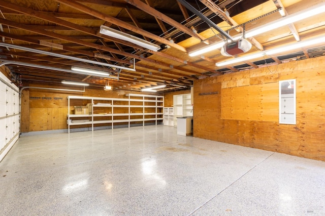 garage with wooden walls and a garage door opener