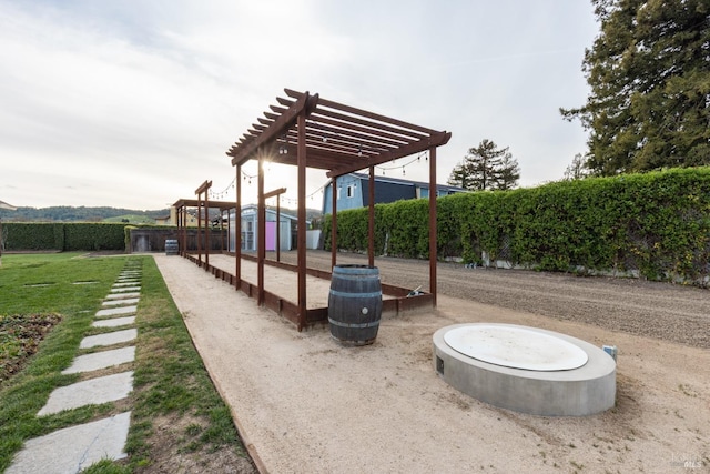 view of home's community featuring a lawn and a pergola