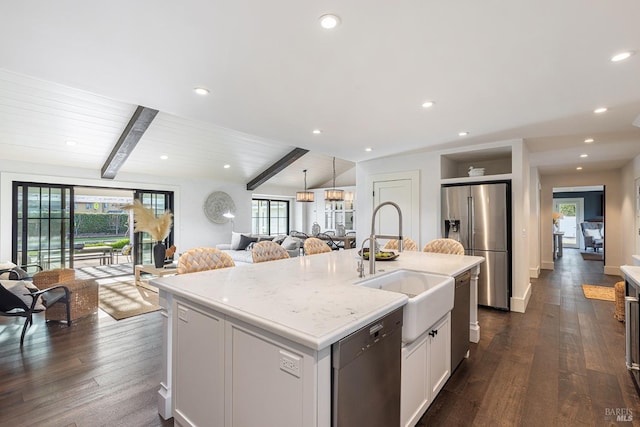 kitchen with an island with sink, stainless steel appliances, dark wood-type flooring, and open floor plan