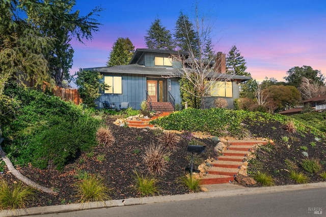 bungalow-style house with fence