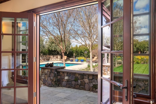 entryway with french doors and stone tile flooring