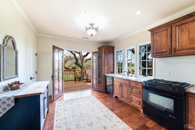 kitchen with dark wood-type flooring, black appliances, ornamental molding, a sink, and french doors