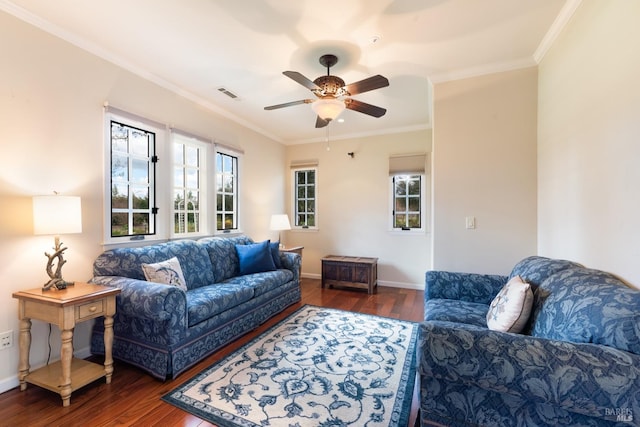 living room with visible vents, crown molding, ceiling fan, baseboards, and wood finished floors