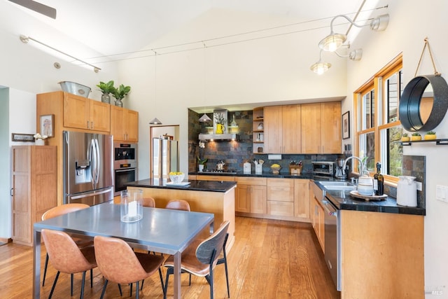 kitchen with open shelves, stainless steel appliances, light wood-style floors, dark countertops, and tasteful backsplash