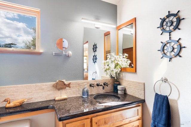 bathroom featuring tasteful backsplash and vanity