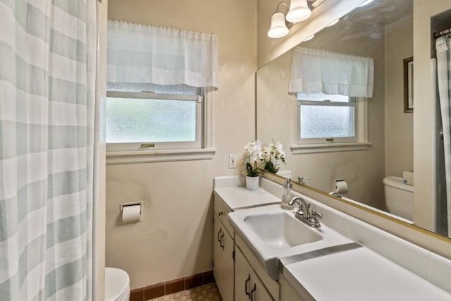 full bathroom featuring vanity, baseboards, a wealth of natural light, and toilet