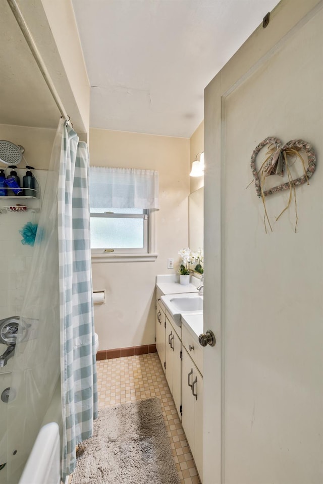 bathroom with toilet, curtained shower, and vanity