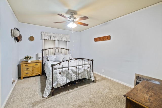bedroom with carpet floors, ornamental molding, baseboards, and ceiling fan