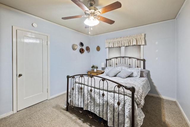 carpeted bedroom with baseboards, ornamental molding, and a ceiling fan