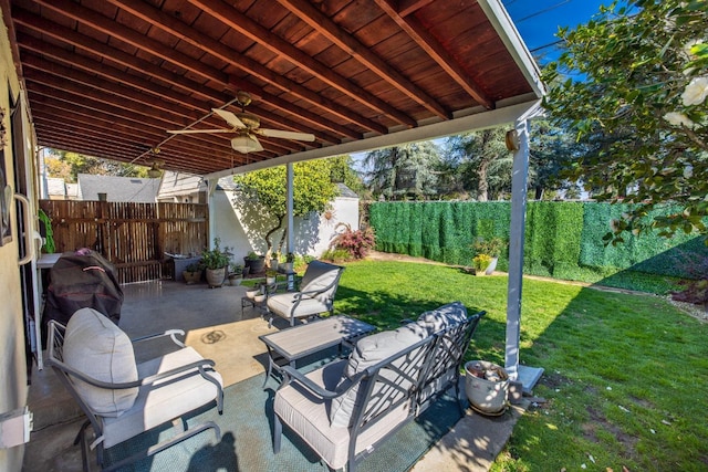 view of patio with a fenced backyard, a ceiling fan, an outbuilding, and a shed