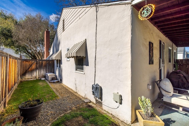 view of home's exterior with a fenced backyard and stucco siding