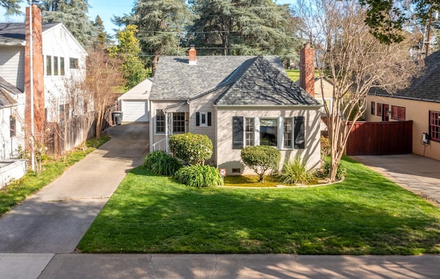 bungalow with fence, a front lawn, stucco siding, an outbuilding, and a chimney