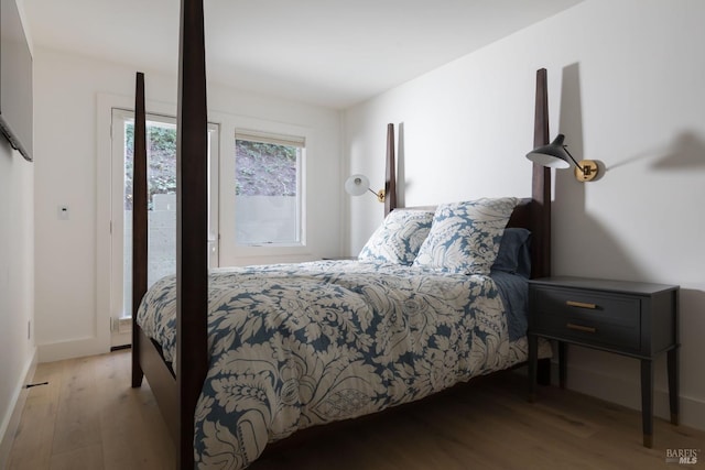 bedroom with baseboards and wood finished floors