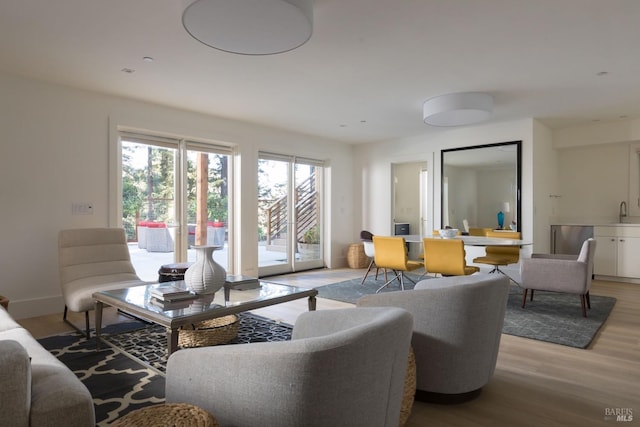 living room featuring light wood-style flooring and baseboards