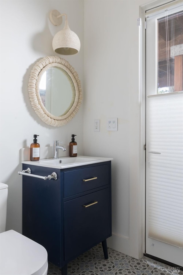 half bath featuring toilet and vanity