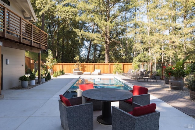 view of pool featuring a patio area, a fenced backyard, outdoor dining area, and a fenced in pool