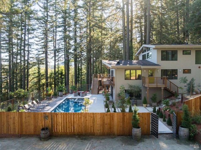 view of swimming pool with a fenced in pool, fence private yard, a patio area, and stairs