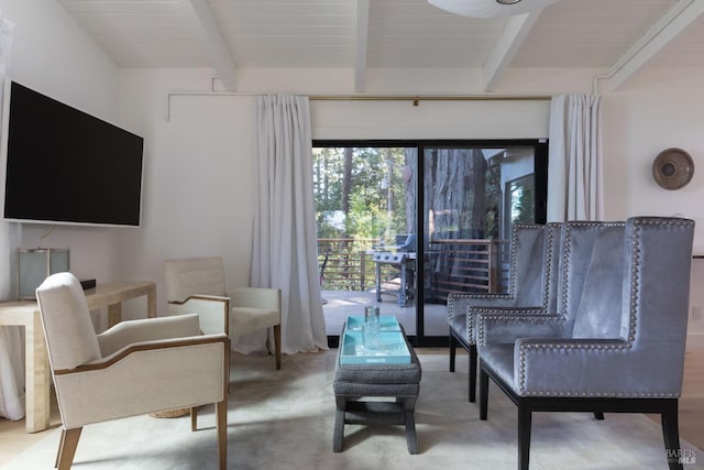 sitting room featuring beam ceiling