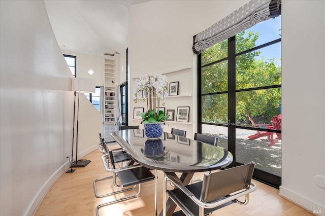 dining room with baseboards and light wood-style flooring