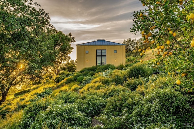 view of property exterior with metal roof and a standing seam roof