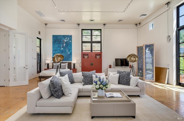 living area featuring visible vents, track lighting, and wood finished floors