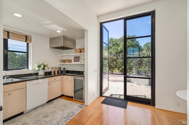 kitchen featuring beverage cooler, open shelves, light wood-style flooring, white dishwasher, and dark countertops