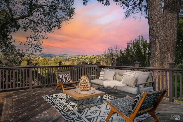 wooden terrace with an outdoor hangout area