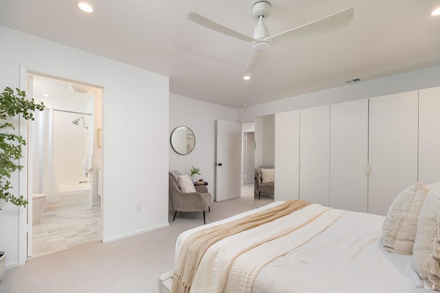 bedroom with ceiling fan, recessed lighting, light colored carpet, visible vents, and ensuite bath