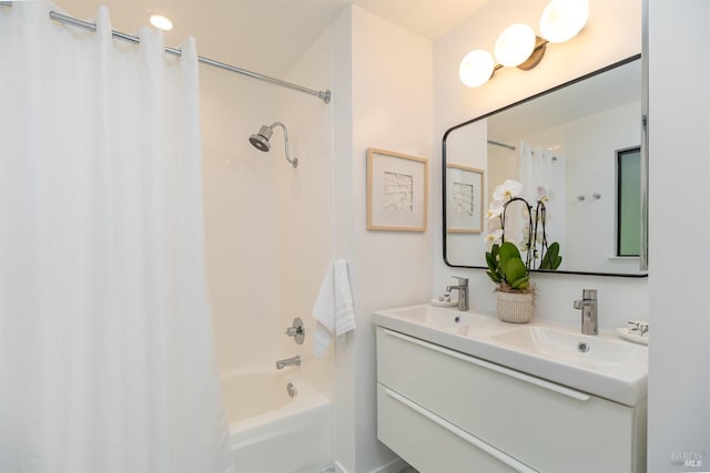 bathroom with double vanity, shower / bathtub combination with curtain, and a sink