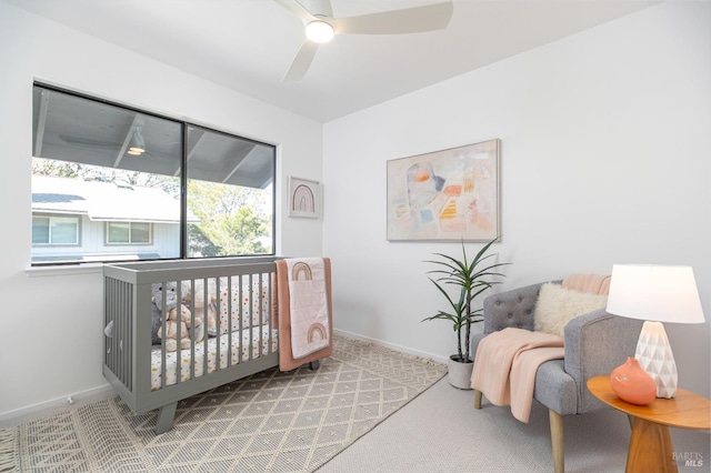 carpeted bedroom featuring ceiling fan and baseboards