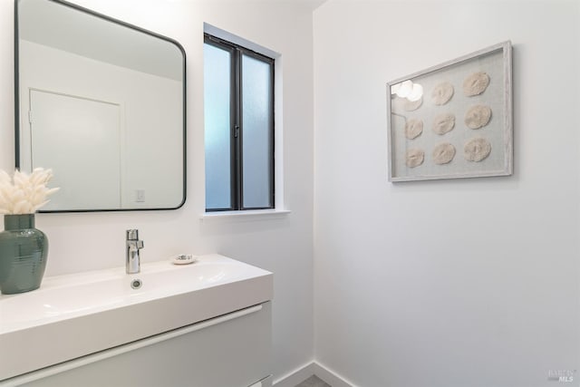 bathroom with vanity and baseboards