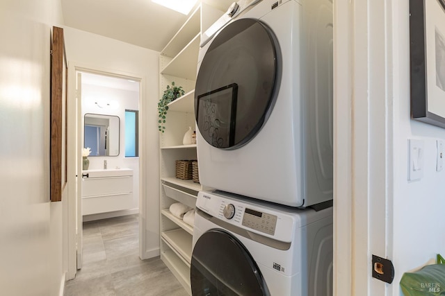 laundry area with laundry area and stacked washer / drying machine