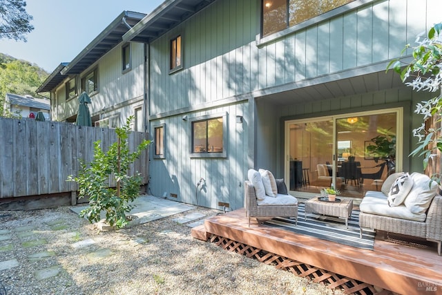 back of property featuring fence and a wooden deck